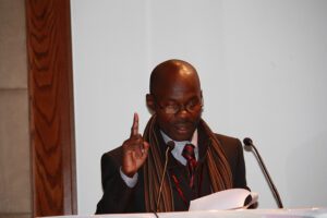 A man in a suit and tie giving a speech.