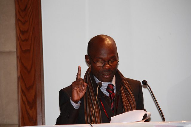 A man in a suit and tie giving a speech.