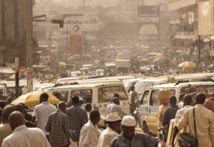 A crowded city street with many people and vehicles.