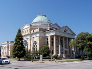 A large white building with a dome on top.