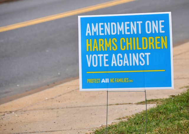A sign that says amendment one harms children vote against.