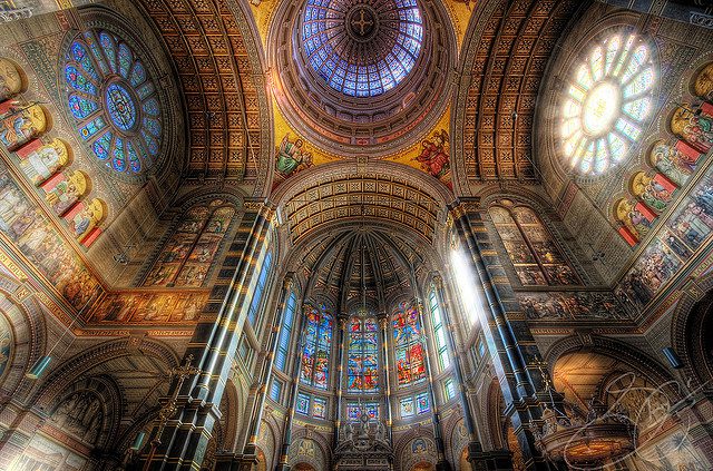 Vaulted dome and rose windows in ornate church