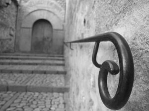 A black and white photo of a stair railing.