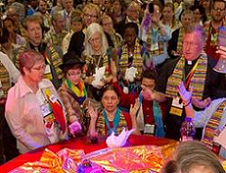 A group of people standing around a table.