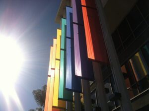 Rainbow flags on the side of a building.