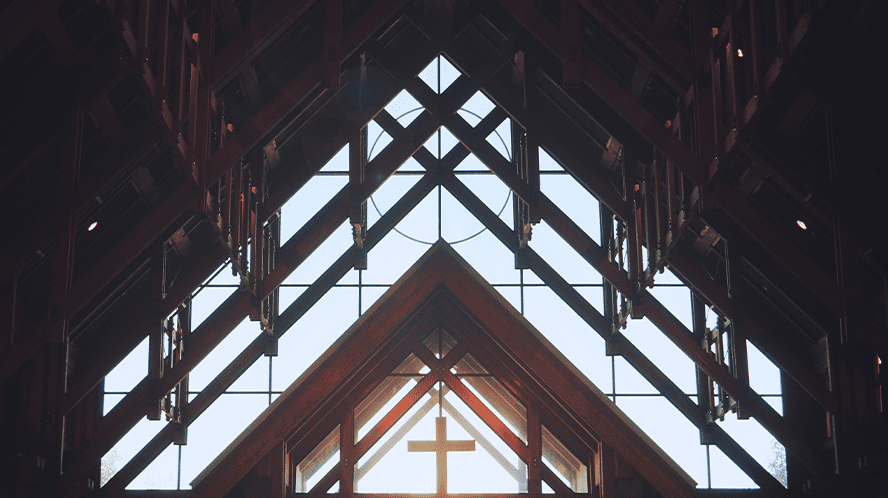 An image of a church with a cross in the window.