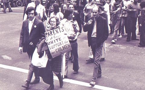 Black and white marchers carrying protest signs
