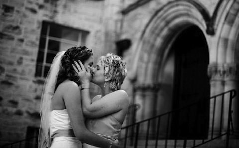 Wedding couple kissing on church steps