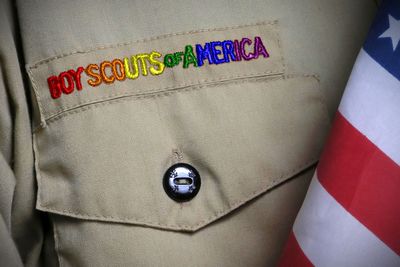 A boy scout's uniform with the words boy scouts of america on it.