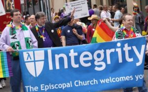A group of people holding a banner that says integrity the episcopal church welcomes you.