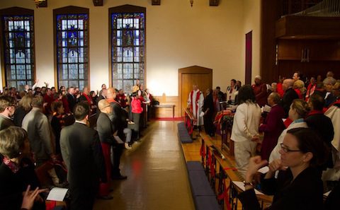 A large group of people standing in a church.