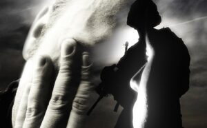 A black and white image of a soldier with his hand on his face.