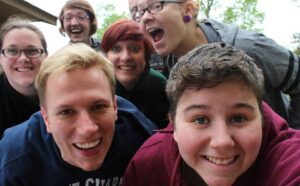 A group of people posing for a selfie.