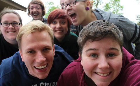 A group of people posing for a selfie.
