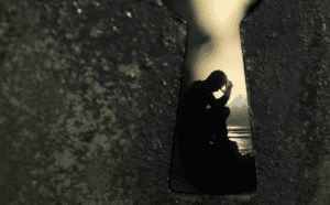 A keyhole with a person in it.