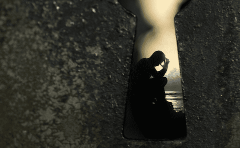 A keyhole with a person in it.