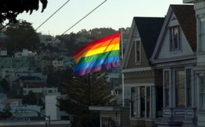 A rainbow flag flies over a house in san francisco.
