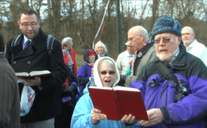 A group of people standing in front of a group of people.
