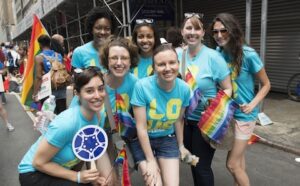 A group of women in blue t - shirts posing for a photo.
