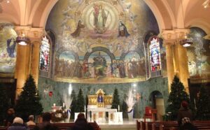 The interior of a church decorated for christmas.