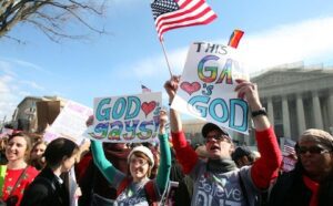A group of people holding signs at the supreme court.