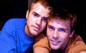 Two young men posing for a picture.