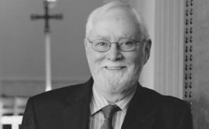 A black and white photo of a man in a suit and tie.