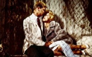 A man and a woman sitting on a couch.