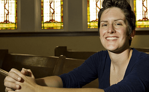 A woman sitting in a church.