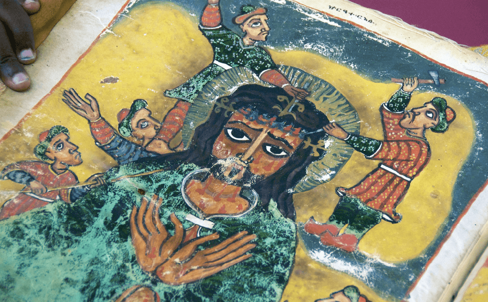 An old book with a painting of jesus on it.