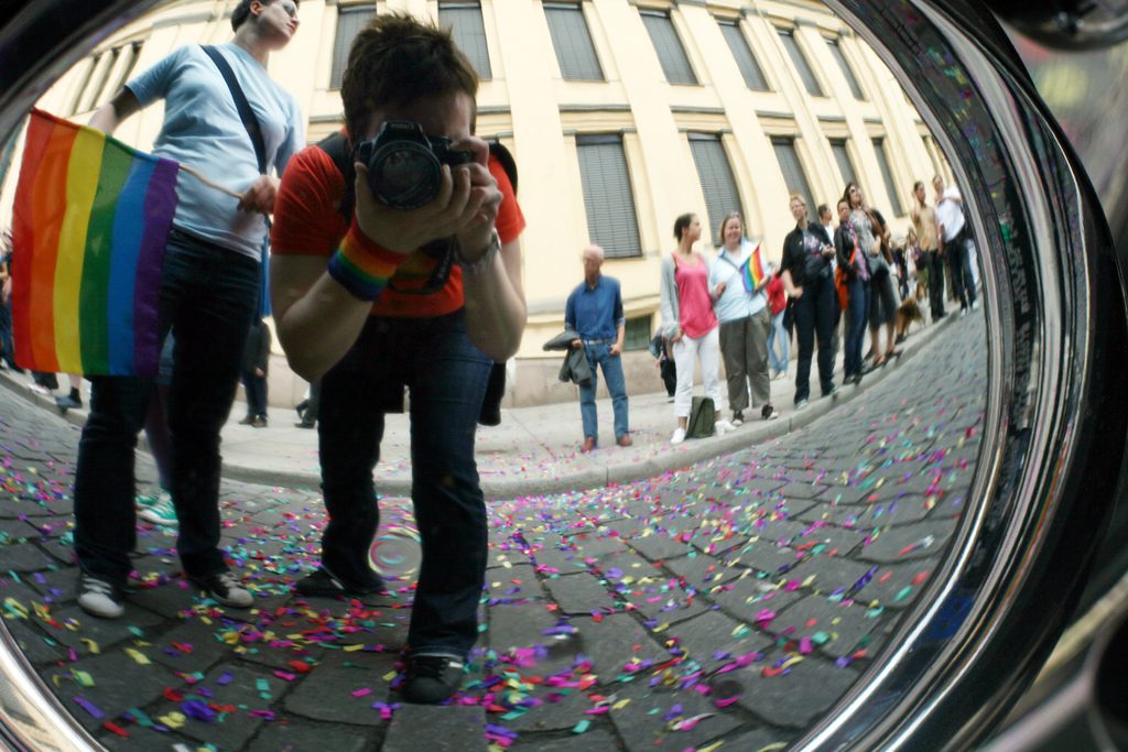 Rainbow flag and confetti on cobblestones