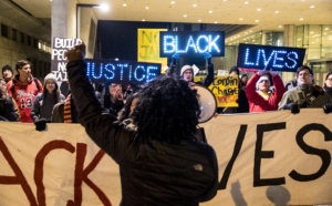 people protesting with banner of black lives matter