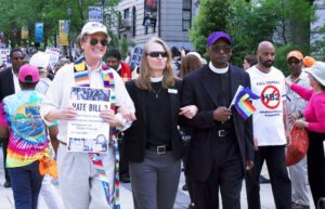 A group of people holding signs and walking down a street.
