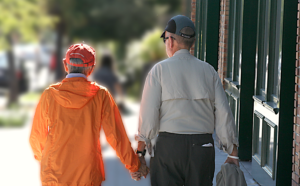 Elderly couple walking hand in hand.