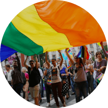 People raising the LGBTQIA+ flag